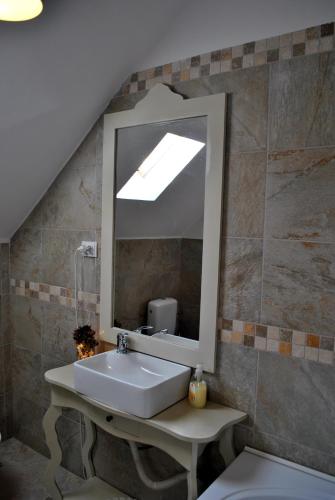 a bathroom with a sink and a mirror at Casa Adalmo in Sighişoara