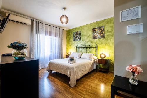 a bedroom with a bed and a vase of flowers at Hotel Gines in Ginés