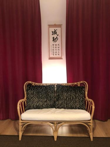 a couch sitting in a room with red curtains at Villa Magdalena in Kutná Hora