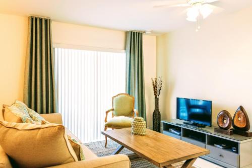 a living room with a couch and a tv at Villa Venezia in Fort Lauderdale