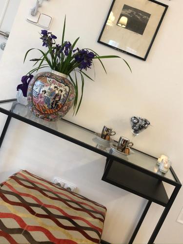 a glass shelf on a wall with a vase on it at Villa Magdalena in Kutná Hora