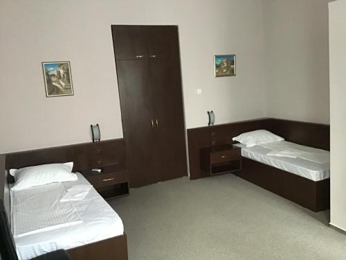 a room with two beds and a mirror at Casa IDA 1896 in Galaţi