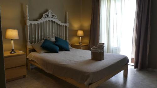 a bedroom with a large bed with blue pillows at Altura Beach Townhouse in Altura