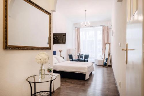 a room with a bed and a table with a mirror at Hungaricum Budapest in Budapest