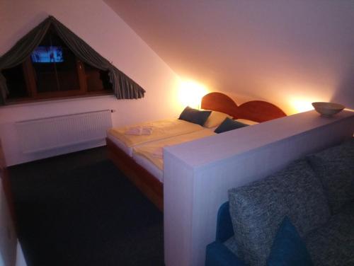 a small bedroom with a bed and a window at Penzion Martin in Janske Lazne