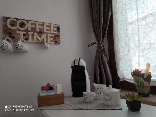 a table with cups and a coffee maker on a window at Chez Mémé in Lesina
