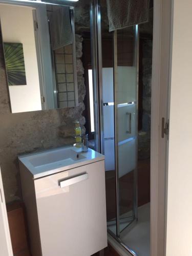 a bathroom with a sink and a refrigerator at Casa Montanyés in Conques