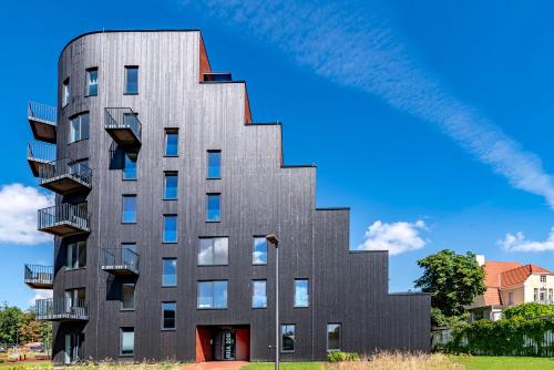 a tall black building with stairs on the side at Artisa Riia Str 20B Luxury Penthouse apartment in Tartu