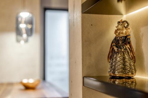 a gold statue on a shelf in a room at Bella Roe Premium Apartments in Belgrade