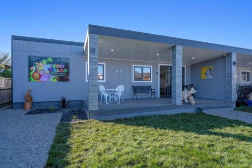 a house with a dog sitting on a porch at Zoo Villas : Villa Zebra - Central Wynyard in Wynyard