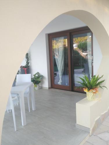 a living room with a table and a window at Villa Orsola in Villaputzu