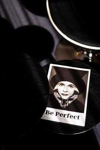 a picture of a woman in a hat on a table at Aris Grand Place Hotel in Brussels