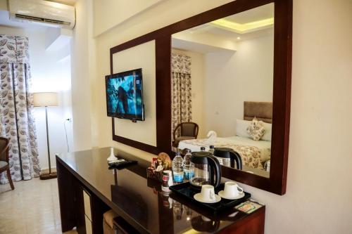 a bathroom with a vanity with a mirror and a bed at Jewel Matrouh Hotel in Marsa Matruh