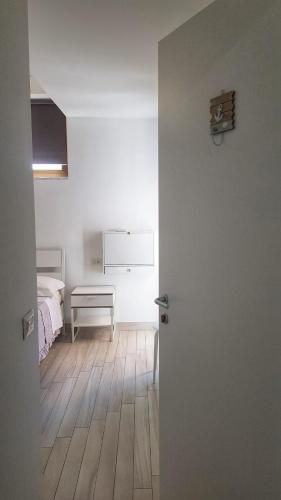 an open door to a bedroom with a bed at Pepi B&B in Santa Maria di Castellabate