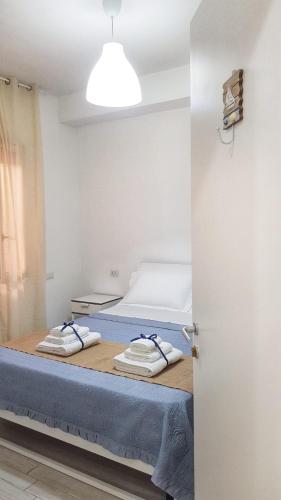a bedroom with a bed with towels on it at Pepi B&B in Santa Maria di Castellabate
