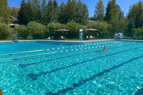 a person swimming in a swimming pool at Single Level Ranch Condo in Elkhorn in Sun Valley