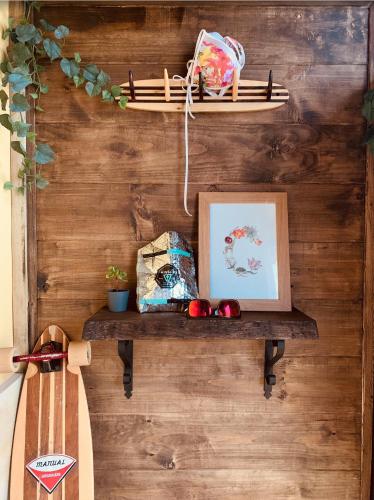 a wall with a shelf with a picture and a surfboard at Las Casitas de Santillana in Santillana del Mar