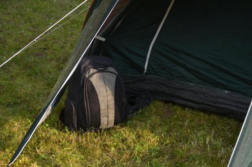 a green tent with a backpack in the grass at Lauku namiņš - Country cottage in Vecpiebalga