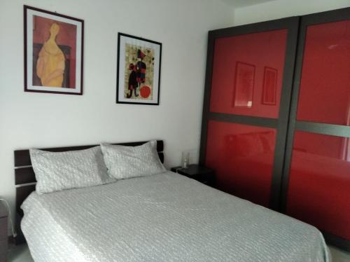 a bedroom with a bed and a red door at Appartamento Nausicaa in Lamezia Terme