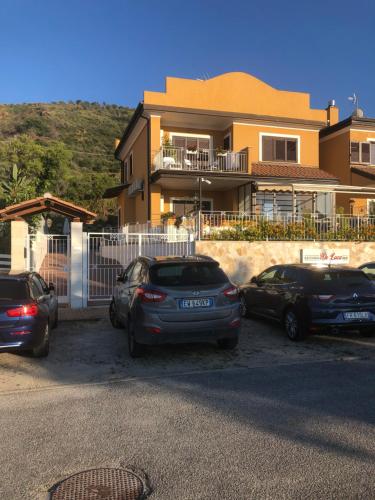 a group of cars parked in front of a house at Residenza De Luca Apartment in Tropea