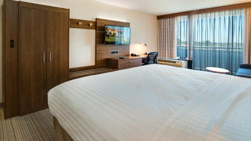 a hotel room with a large bed and a large window at Holiday Inn Express Fullerton-Anaheim by IHG in Fullerton