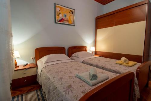a bedroom with two beds with hats on them at Apartman Ivan in Drniš