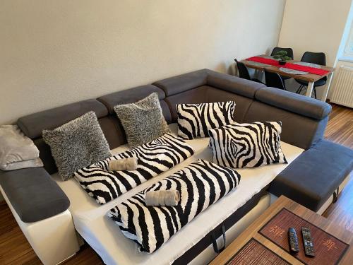 a couch with zebra pillows on it in a room at APARTMENT A&D CENTRUM in Poprad