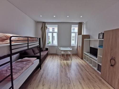 a bedroom with two bunk beds and a desk at Vienna Prater Apartments in Vienna