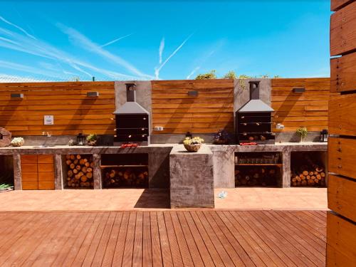 a building with a patio with a wooden wall at Las Casitas de Santillana in Santillana del Mar