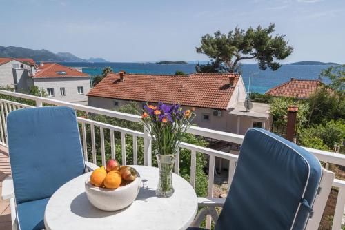 a bowl of fruit on a table on a balcony at Colonia Apartments in Orebić