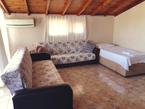 a living room with a bed and a couch at Dove Apart Hotel in Fethiye