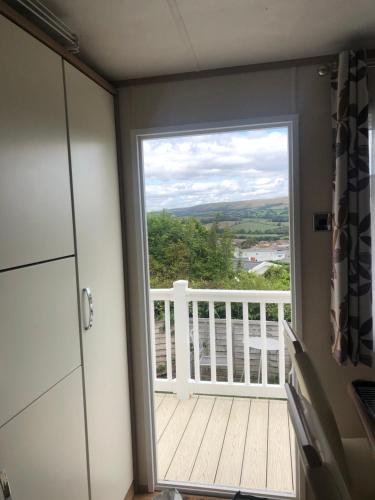 a door leading to a balcony with a view at 225 Buttercup Swanage Bay View - Vacation Home in Swanage