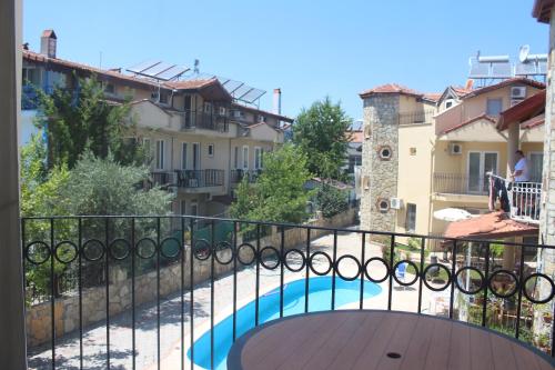 a balcony with a view of a swimming pool at Dove Apart Hotel in Fethiye