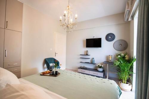 a bedroom with a bed and a chandelier at Cozy and Style in Preveza
