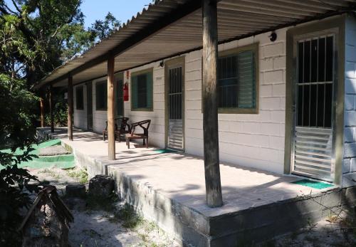 a porch of a house with a bench on it at Nosso Chalé na Ilha in Cananéia