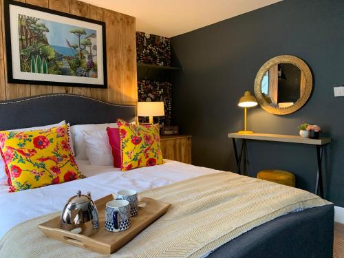 a bedroom with a bed with a tray on it at Sherlocks lodgings in Whitby
