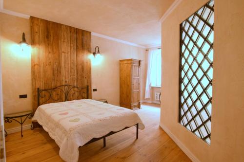 a bedroom with a bed and a large window at Apartament Rustical in Wrocław
