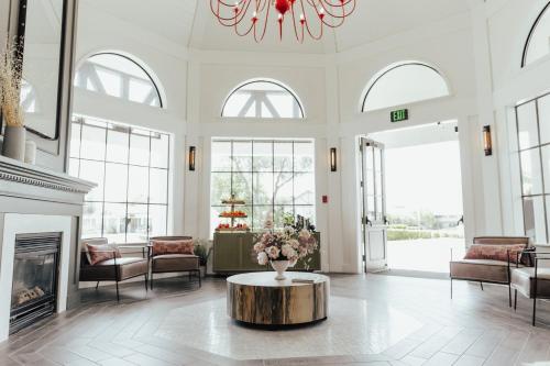 a living room with a fireplace and a vase of flowers at Vinland Hotel and Lounge in Solvang