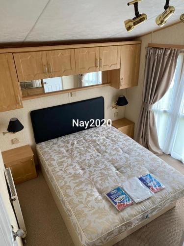 a bedroom with a bed with the word may on it at Fantasy Lodge Sunnymede in Ingoldmells