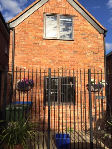 a fence in front of a brick building at Binfield Annexe in Bracknell