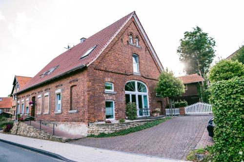 a brick house on a cobblestone street at Klärchen's Stube in Telgte