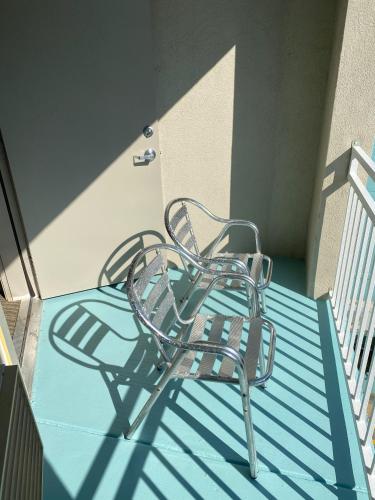 a metal chair sitting on top of a balcony at Holiday Inn Express & Suites Galveston West-Seawall in Galveston
