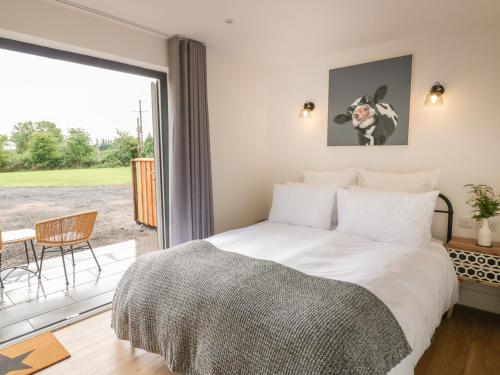 A bed or beds in a room at Monarch's Barn