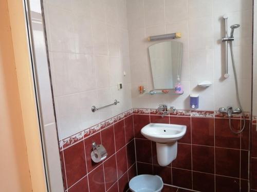 a bathroom with a toilet and a sink and a shower at Guest House "Zora - Sarafovo" in Burgas