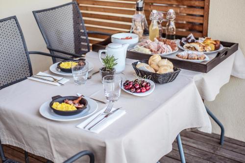 a table with plates of food on top of it at Agriturismo Al Maniero in Trento