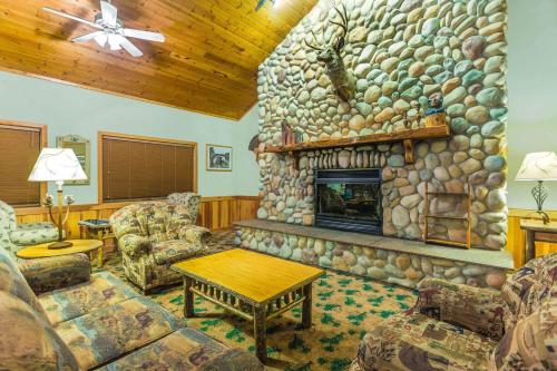 a living room with a large stone fireplace at AmericInn by Wyndham Wisconsin Dells in Wisconsin Dells