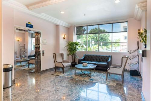 a lobby with a couch and chairs and a table at Days Inn by Wyndham Santa Monica/Los Angeles in Los Angeles