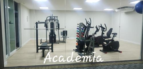a gym with treadmills and ellipticals in a room at Apart-Hotel Golden Lake 2 in Arraial do Cabo