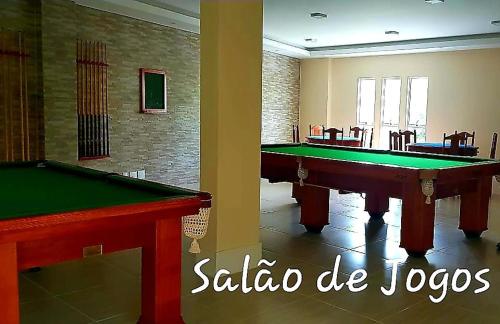 a room with a pool table in a room at Apart-Hotel Golden Lake 2 in Arraial do Cabo