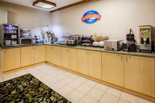a kitchen with a counter in a restaurant at Baymont by Wyndham Mackinaw City in Mackinaw City